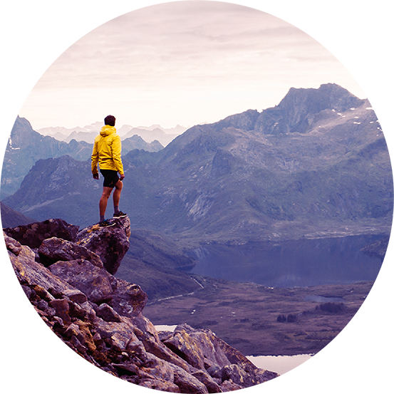 man standing on the edge of a mountain