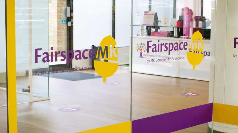 Fairspace MK interior glass panels manifested with company branding in purple and yellow